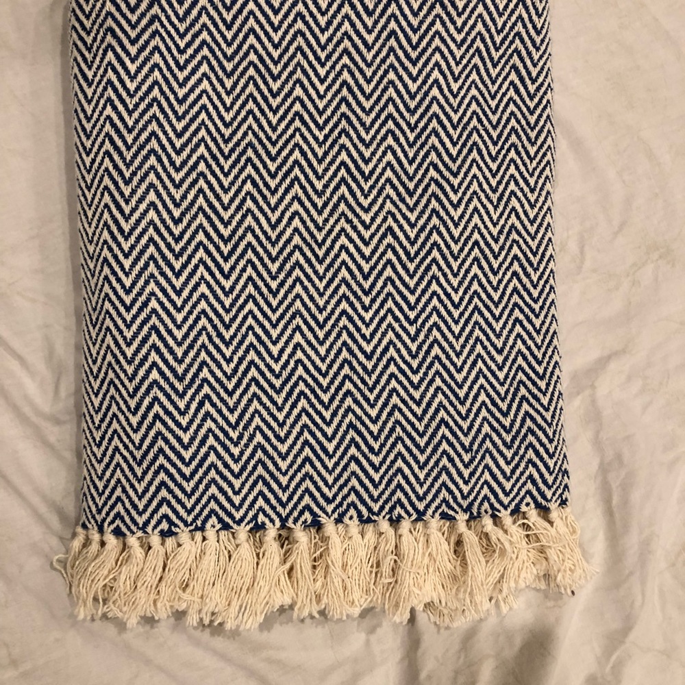 Blue and cream throw blanket with tassels